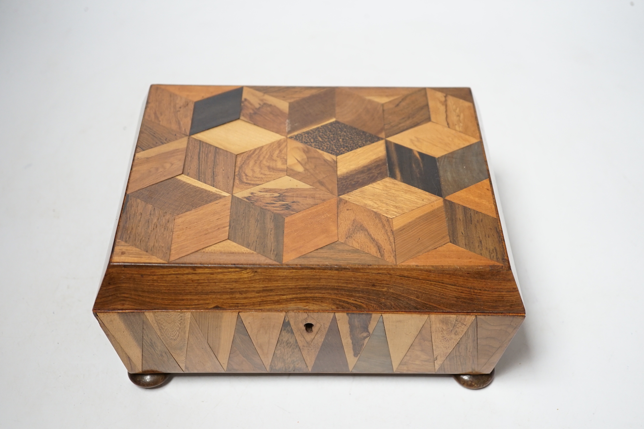 A Victorian specimen wood perspective cube parquetry workbox and contents, 22cm